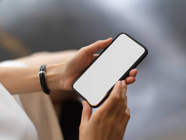 istock Close up view of female using smartphone include clipping path screen in her hands 1311207166
