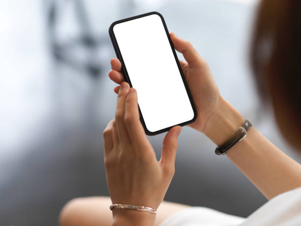 istock Close up view of female using smartphone include clipping path screen in her hands 1311207712