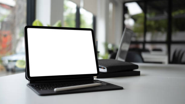 istock Close up view mock up digital tablet with wireless keyboard on white table in meeting room. 1311207935