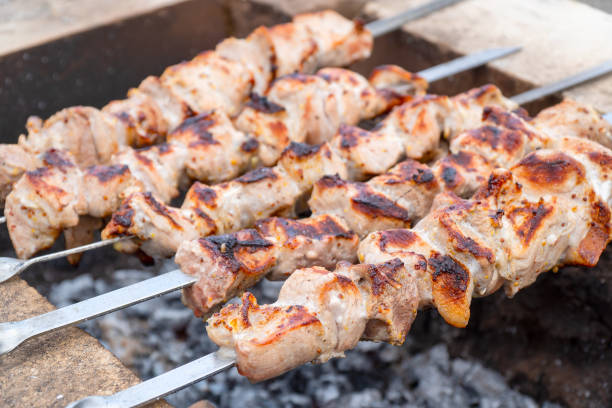 istock Roasted meat cooked at barbecue and skewers during picnic 1311208778