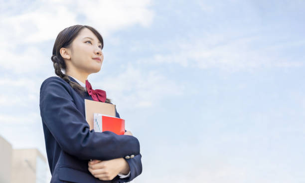 istock Asian female high school student looking up to sky. 1311211518