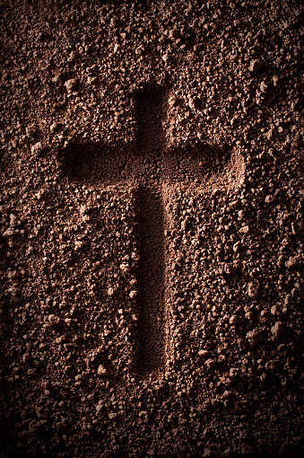 Cross drawn in the soil.