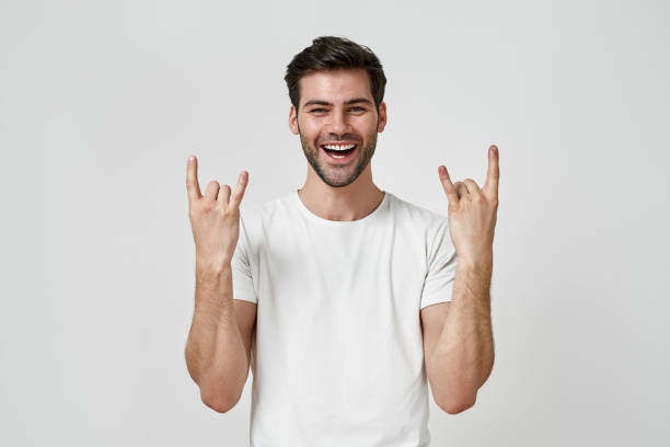 istock Man wearing t-shirt doing rock symbol 1311213316