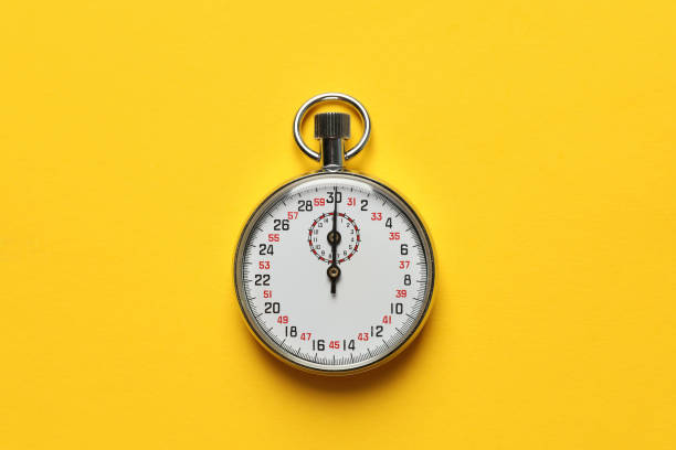 istock Vintage stopwatch on yellow background, top view 1311213647