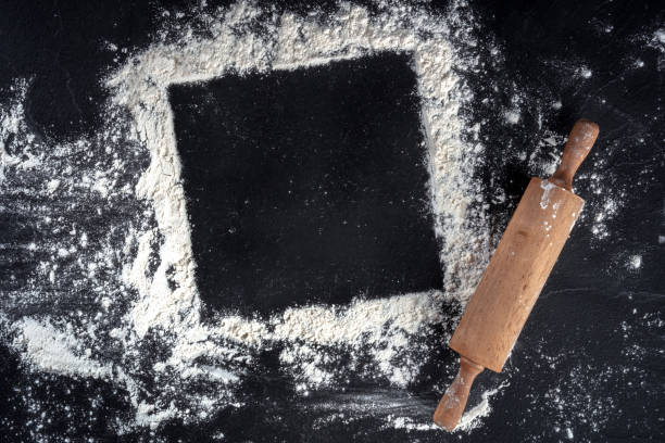 istock Baking frame with copy space, white flour and a wooden rolling pin 1311217736