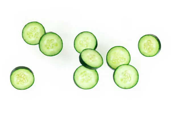 Photo of Cucumber slices, levitating on a white background