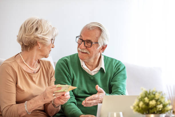 istock Senior couple looking stressed out while managing their paperwork together at home 1311218844