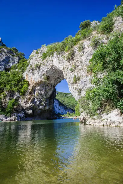 Photo of The Pont d'Arc, a large natural bridge located in the Ardèche département in the south of France, 5 km from the town of Vallon-Pont-d'Arc
