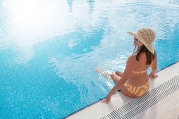 istock Woman relaxing in swimming pool 1311219893