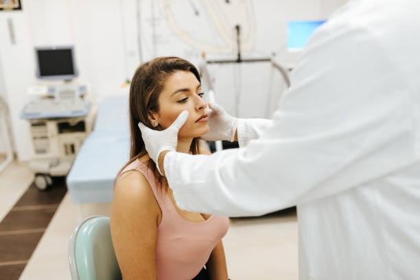 Male doctor examined female patient Male doctor examined female patient sinusitis photos stock pictures, royalty-free photos & images