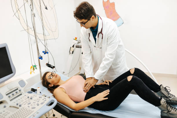 istock Doctor examining abdomen of patient 1311222320