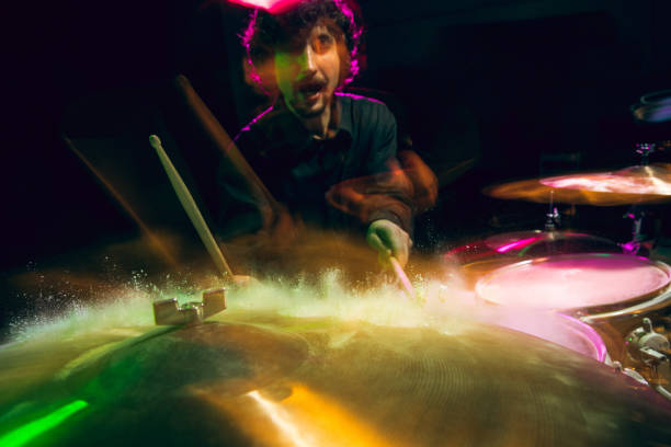istock Drummer's rehearsing on drums before rock concert. Man recording music on drumset in studio 1311223143