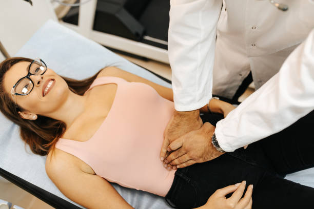 istock Doctor examining abdomen of patient 1311223636