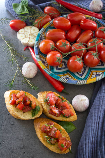 istock Tasty bruschetta with roasted tomatoes and basil. 1311224523