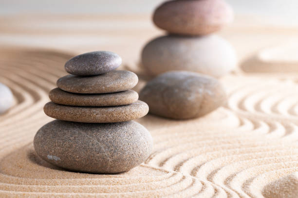 istock Japanese zen garden with stone in raked sand 1311224733