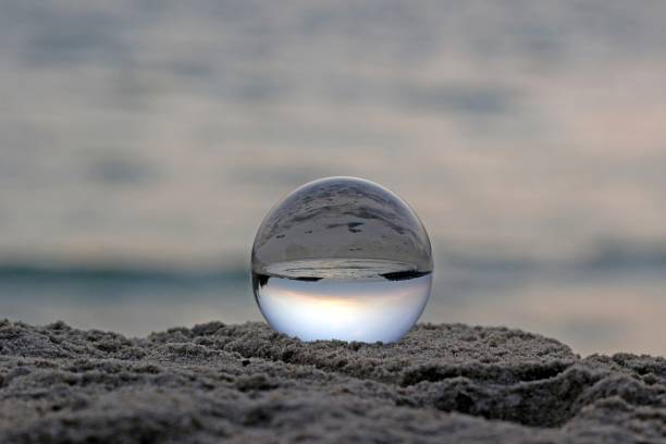 istock Clear crystal ball with view of beach and ocean 1311226433