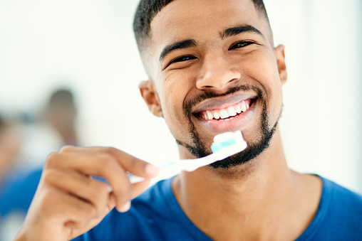 Shot of a young man preparing to brush his teeth