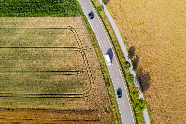 istock Three Cars on the Road Between Fields, Aerial View 1311228434