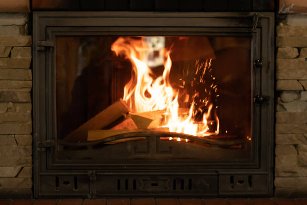 istock Fire in an old cast iron fireplace. Fire in the form of a human face. 1311228589
