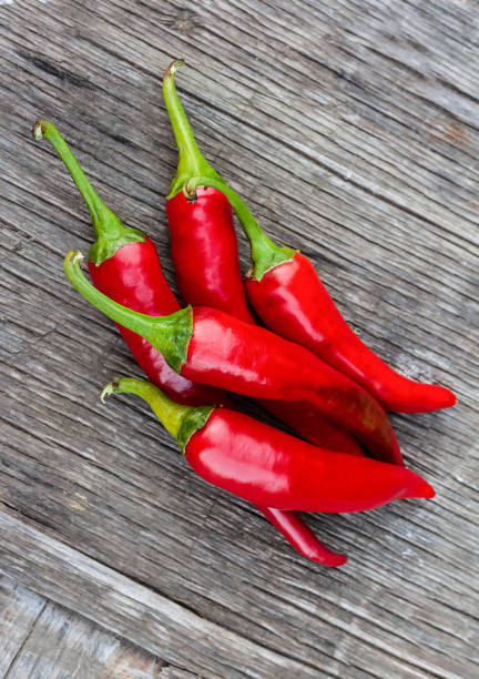 istock Red chili peppers on a wooden table 1311228909