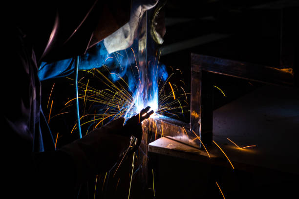 istock A man welder with construction gloves and a welding mask is welded with a welding machine metal in workshop. 1311229192