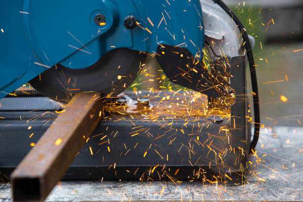istock Iron pipe cutting saw for metal with bright sparks close up. 1311229193