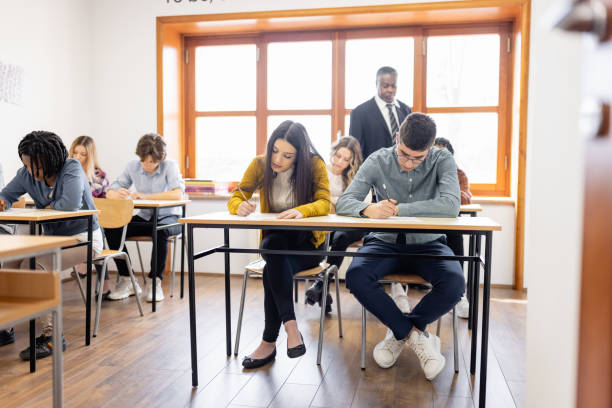 istock Male teacher supervising the class during a school exam 1311230267