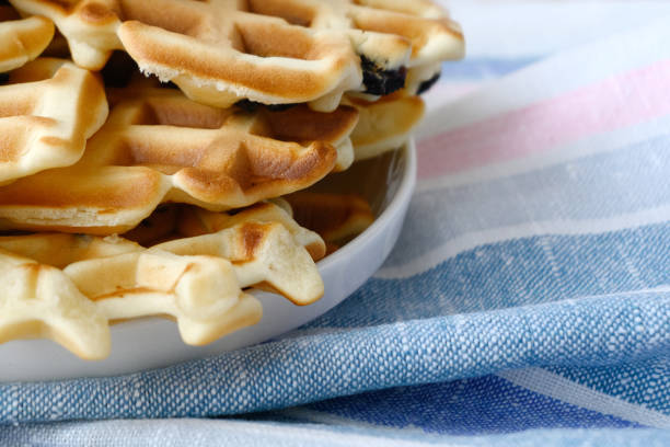 istock Stack of fresh baked hot waffles on kitchen towel 1311230601