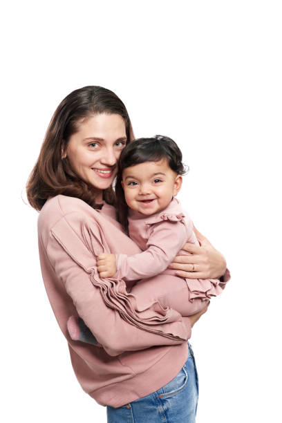 istock Mother holding baby daughter isolated on white. 1311231573