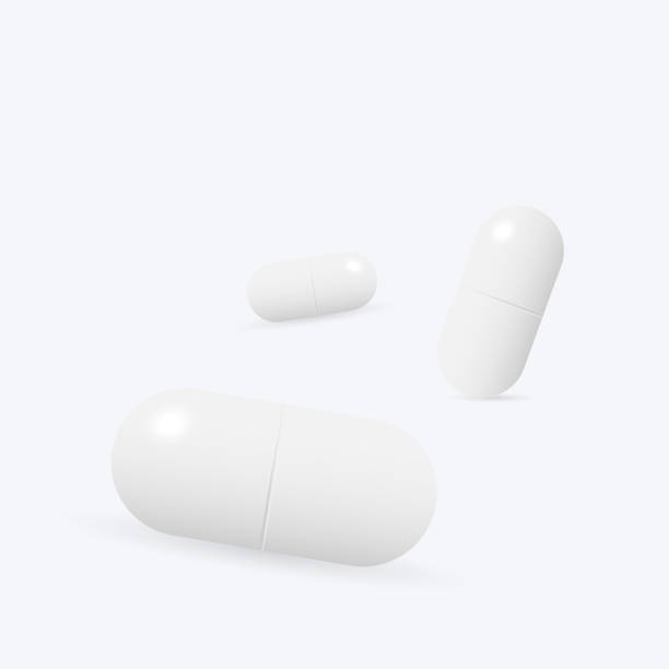 istock Two white medicine capsules. Medicament pills. Pharmaceutical drugs. 1311231701