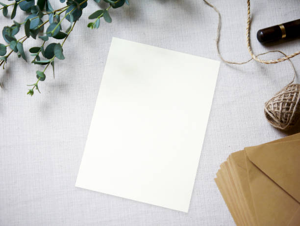 istock Top view mockup blank card, for greeting, wedding invitation template with eucalyptus leaves on cloth background. 1311231732