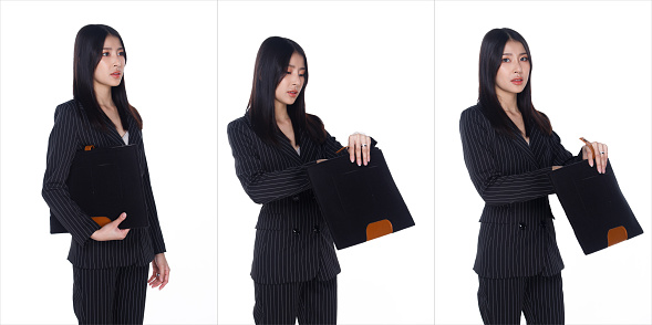 Half Body Portrait of 20s Asian Woman black hair formal black strip suit. Office Girl look inside Brief document bag and use to work over white Background isolated