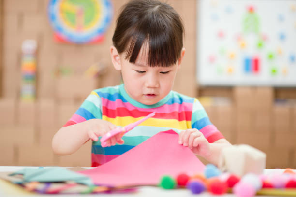 istock Young Girl Using Scissors Cutting Papper For Making Craft For Homeschooling 1311232924
