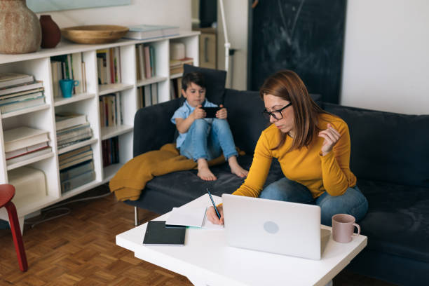 istock mother works from her home. child is beside her playing 1311233116