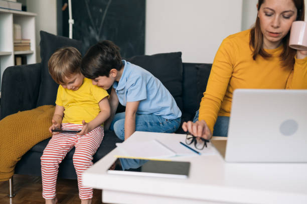 istock mother works from her home. child is beside her playing 1311233328