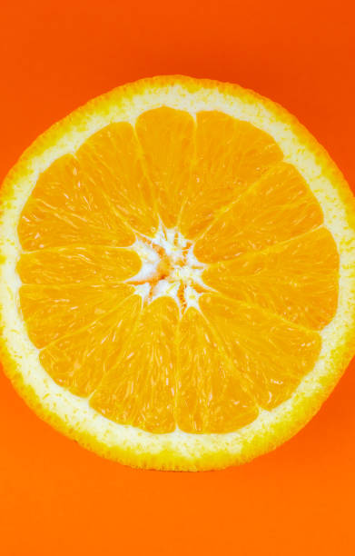 istock Orange fruit on orange background.  Minimalism, original beautiful photo. 1311234380