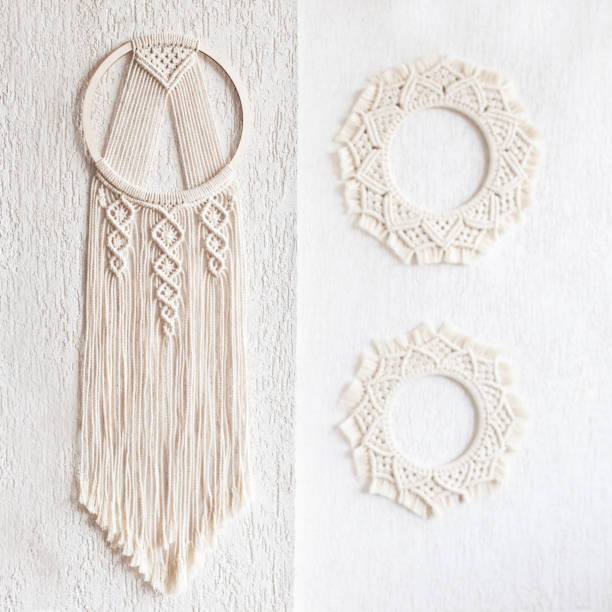 istock Handmade cotton macrame Dream catcher on white wall background. Traditional amulet for protecting sleep.  Macrame lace home decor on the wall with green leaves. Woman hobby. 1311234582