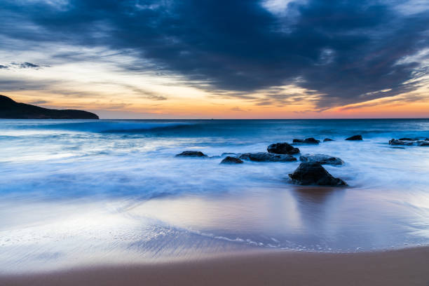 istock Sunrise at the beach with high cloud 1311234628