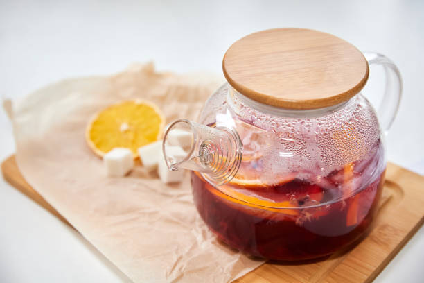 istock Berry tea with orange in a transparent teapot on light background. Close-up, selective focus 1311236991