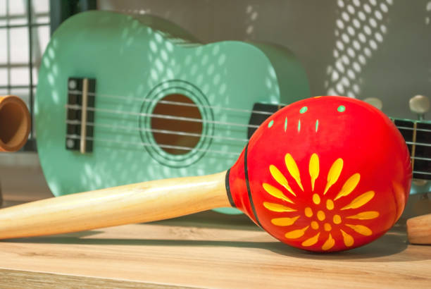 Red maracas and green small Ukulele guitar sale in music shop Red maracas and green small Ukulele guitar on wooden shelf sale in shop. Mexican traditional musical instruments set selling in music store rumba photos stock pictures, royalty-free photos & images