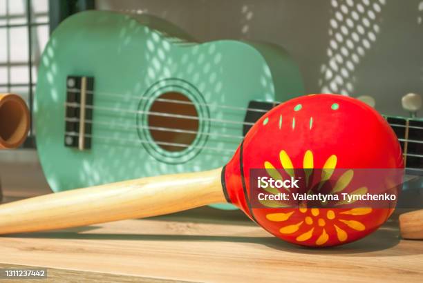 Red Maracas And Green Small Ukulele Guitar Sale In Music Shop Stock Photo - Download Image Now