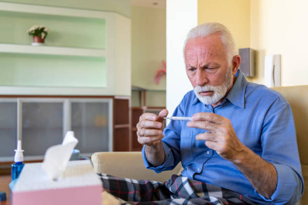 istock Sick Senior Man Caught a Flu Virus and Feeling Worried Due to High Temperature. 1311237840