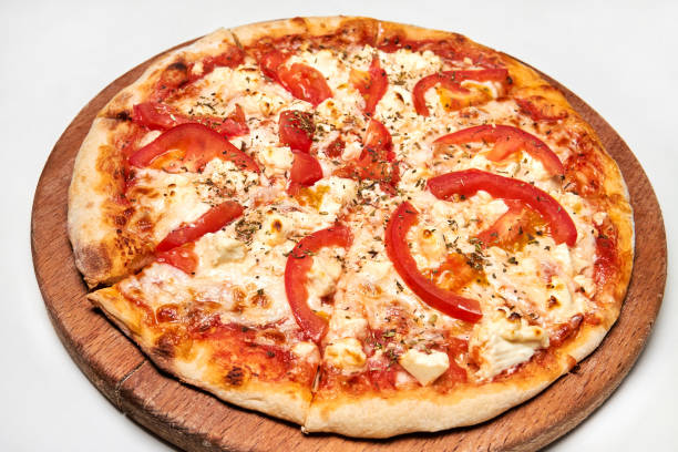 istock Pizza with bacon, bell pepper, tomatoes and cheese on wooden board. Close-up, selective focus 1311240051