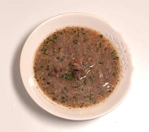 istock soup in a plate close-up on a light background. 1311240497