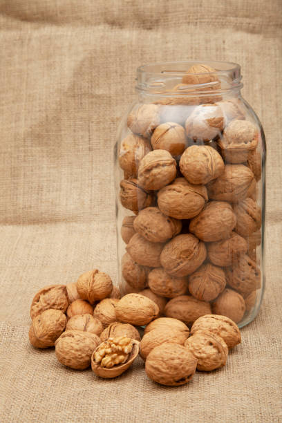istock Organic walnuts on burlap. Food background. 1311241301