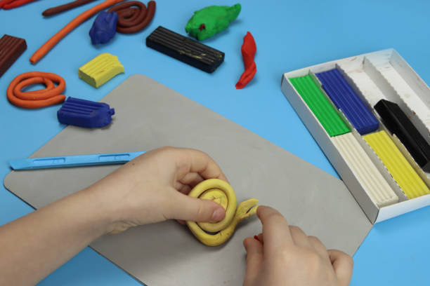 istock child makes various figures from colored plasticine, hands close-up 1311241417