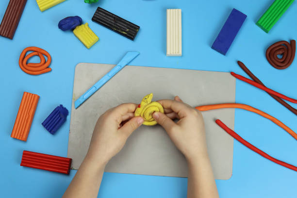 istock child makes various figures from colored plasticine, hands close-up 1311241426