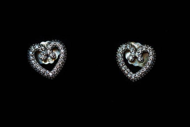 istock Beautiful silver earrings isolated on black, close up 1311241606