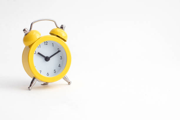 istock Small yellow alarm clock with bell isolated on white background. 1311242031