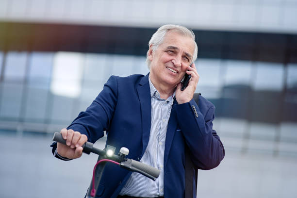 istock Businessman talking on mobile phone on his electric scooter 1311242884